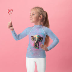 Kid wearing Dreamy Gazes Rash Guard while playing in the sand.