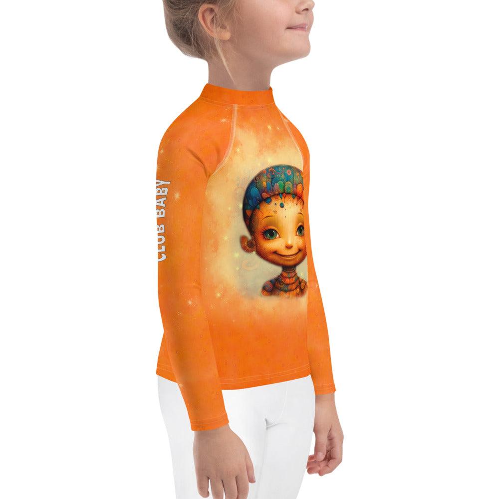 Angelic Peepers Kids Rash Guard laid out on sand with beach toys.