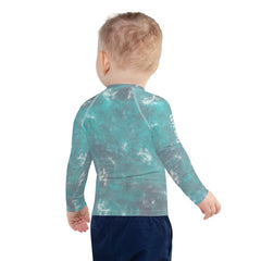 Child playing in the water wearing Elephant Parade Rash Guard.