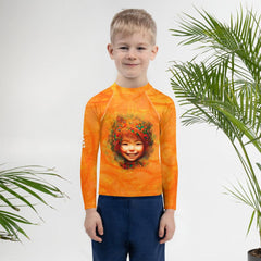 Kid enjoying swimming wearing the Enchanted Iris Kids Rash Guard.