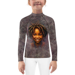 Child playing on the beach in enchanted pupil rash guard.