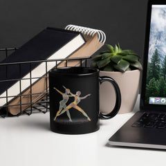 Black glossy mug featuring silhouette of dancing women design.