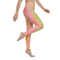 Athletic woman wearing Enraptured Yoga Leggings stretching in studio