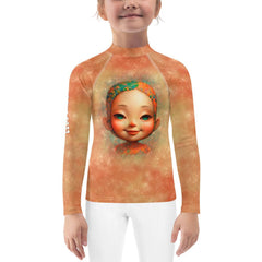 Kids playing in the sand wearing Ethereal Youthful Gazes Rash Guards.