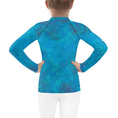 Side view of kid modeling Fairyland's Stars Rash Guard.