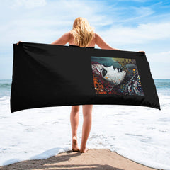 Graphic Glory Towel with vibrant abstract design laid on beach sand.