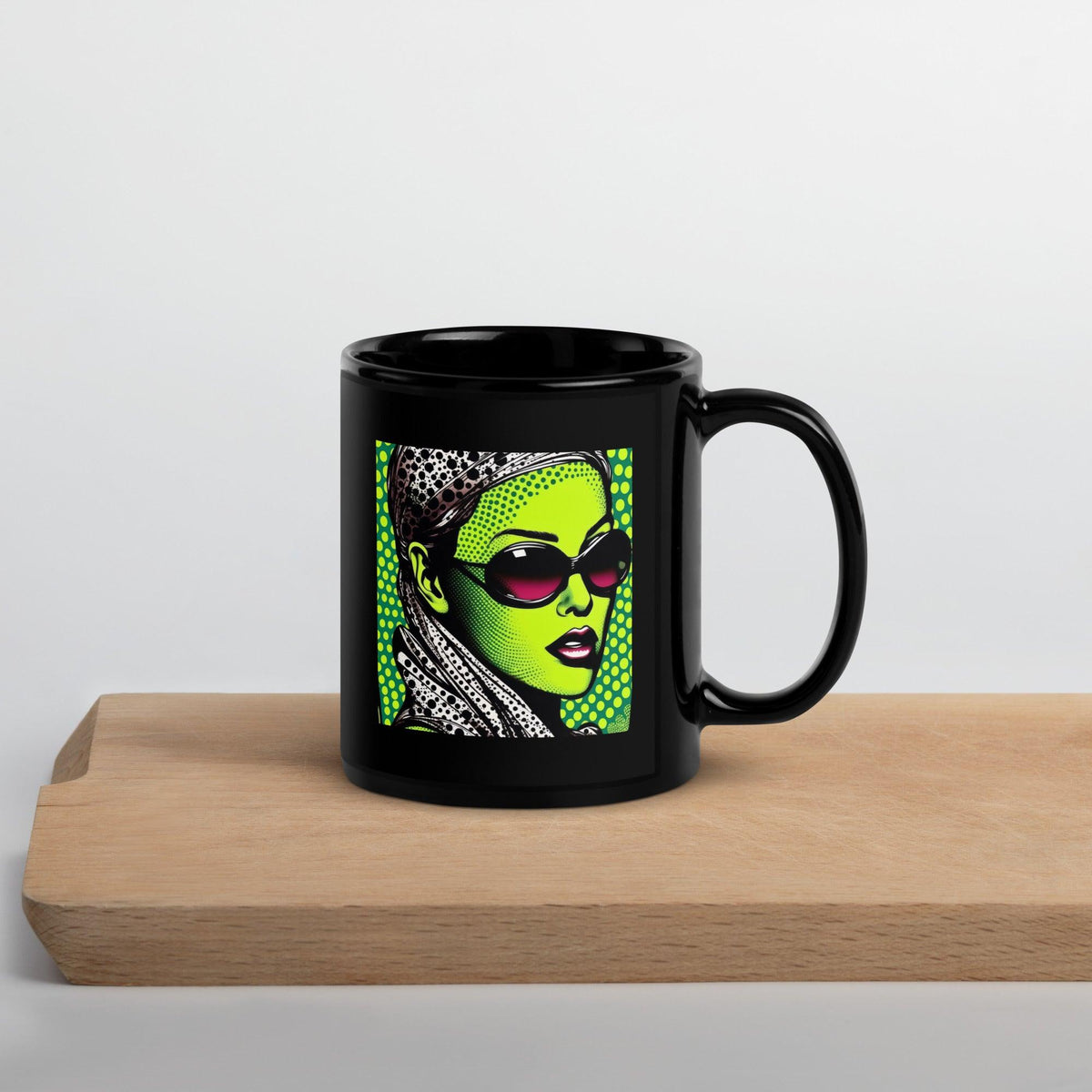 Close-up of black glossy mug with inked design.