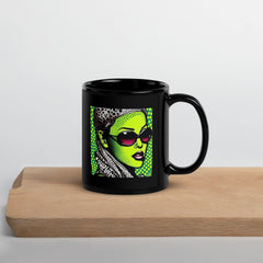 Close-up of black glossy mug with inked design.