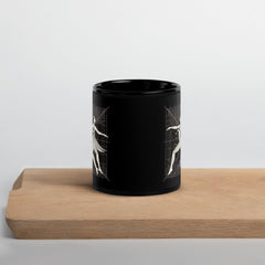 Elegant black glossy mug with balletic design detail.