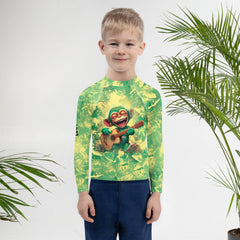 Kids playing in 'Mischief In Their Eyes' Rash Guard on beach.