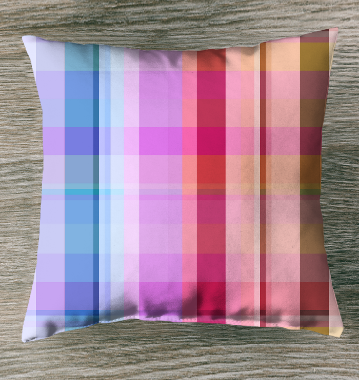 Rainbow Spectrum Outdoor Pillow displayed on a patio chair, showcasing its vibrant and colorful rainbow pattern.