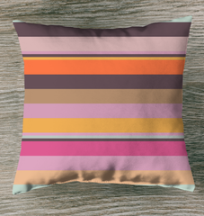 Electric Sunrise Stripe Outdoor Pillow on a garden swing.