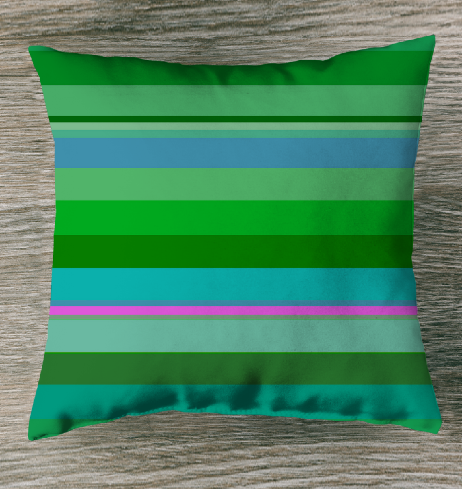 Tropical Paradise Stripe Outdoor Pillow on a sunny poolside lounger.