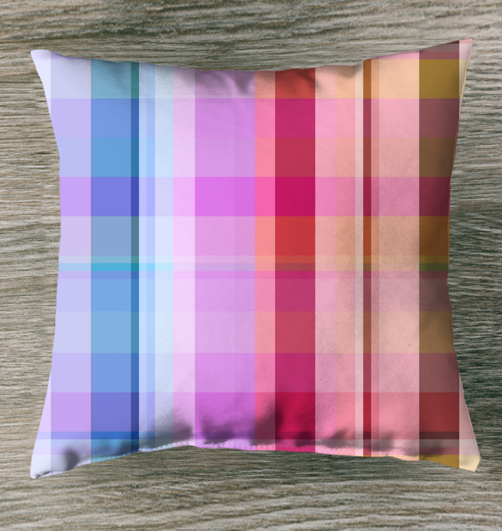 Rainbow Spectrum Indoor Pillow displayed on a couch, showcasing its colorful boxed stripe design.