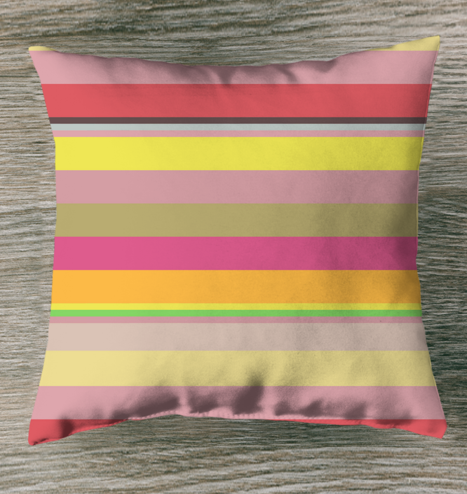 Galactic Rainbow Stripe Outdoor Pillow in a star-themed garden setting.