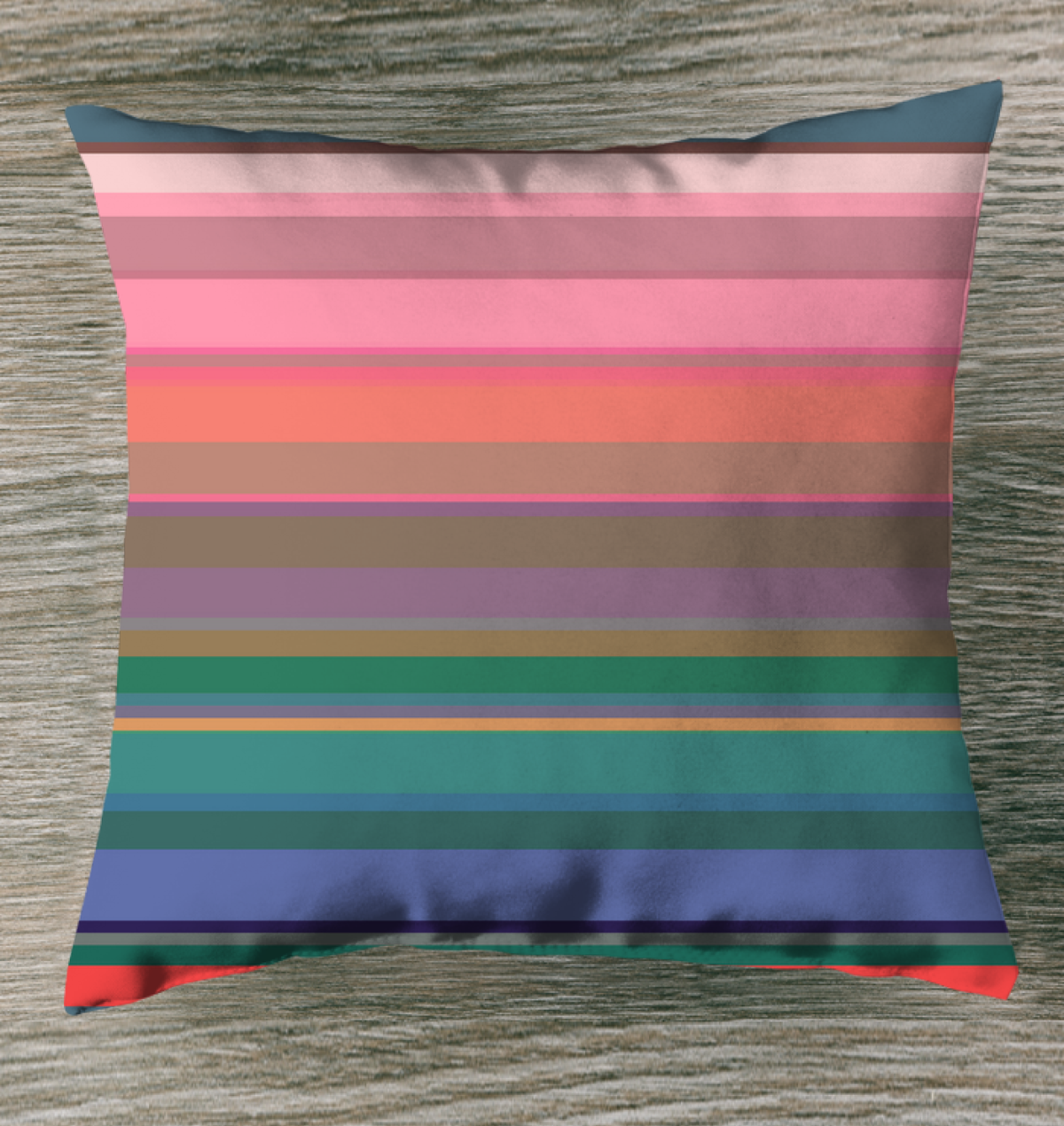 Rainbow Bliss Stripe Outdoor Pillow on a sunny deck chair.