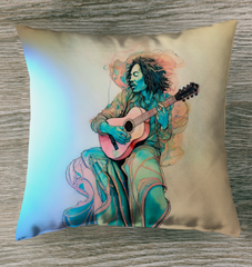 Serenades Sunset Outdoor Pillow on a cozy deck chair at dusk.