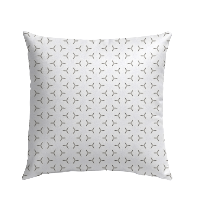 Geometric pattern monochrome maze pillow in garden setting.