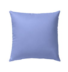 Ocean Breeze outdoor pillow on patio chair showcasing vibrant colors and design.