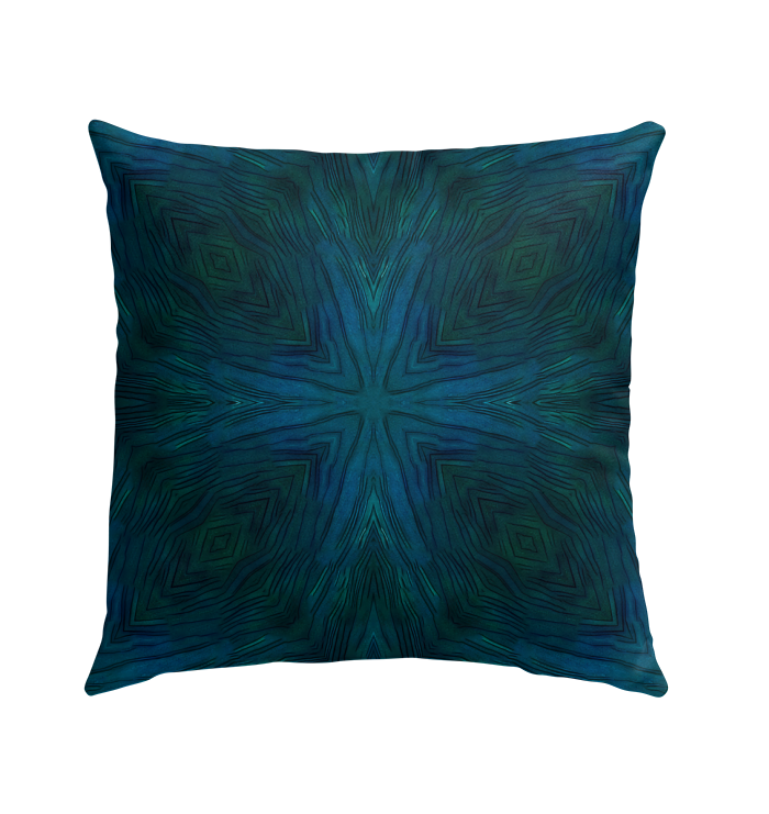 Outdoor pillow with rainbow design placed in a garden setting, enhancing outdoor decor.