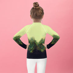 Young surfer sporting the Radiant Gaze of Nature Rash Guard.