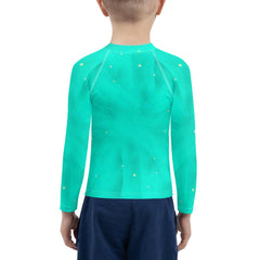 Regal Gaze Collection kids rash guard on a beach backdrop.