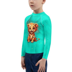 Happy child in Regal Gaze rash guard playing at the seaside.