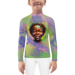 Child wearing Seraphic Sparkling Eyes Rash Guard at the beach.