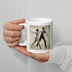 Theatrical ballet-inspired glossy white mug on a kitchen counter.