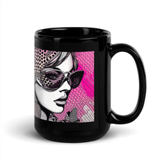 Hand holding Visual Visions II glossy black mug filled with coffee.