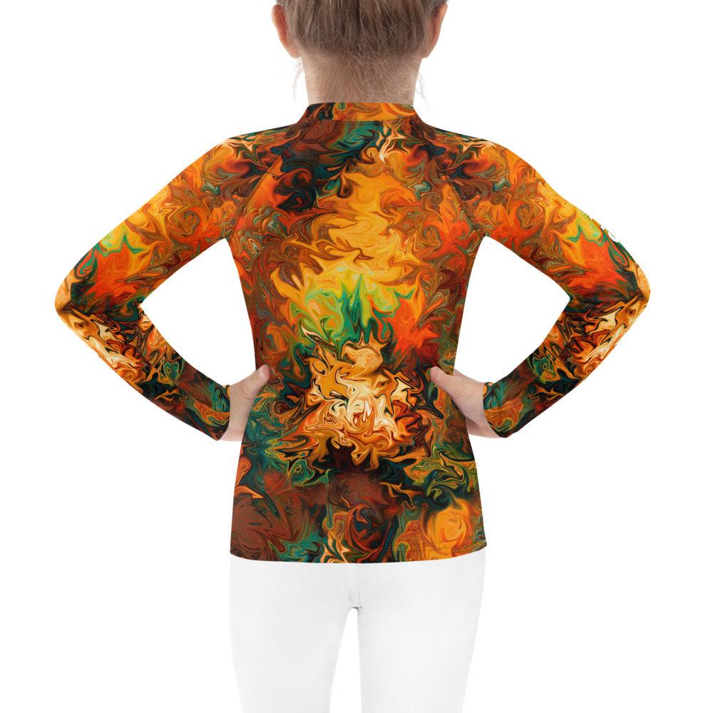 Whimsical Sparkling Glances Rash Guard on beach backdrop.