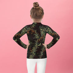 Back view of child in Whimsy in Their Eyes rash guard looking at the sea.