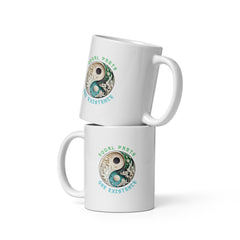 White glossy mug with vibrant interstellar orbit design.