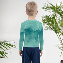 Child enjoying water activities wearing the protective Wondrous Childlike Gaze Rash Guard.
